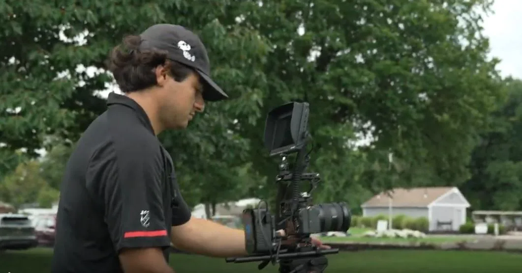 Camera operator filming on the course