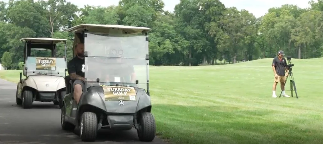Two Tuesday Golf carts heading out past the camera